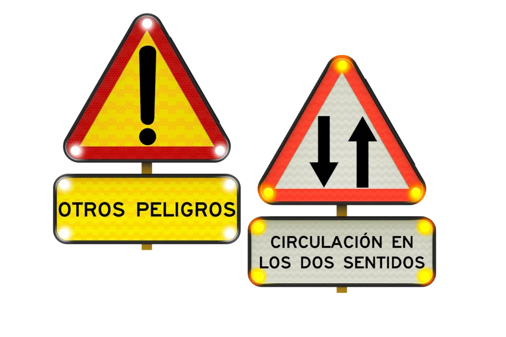 Conjunto de señales triangulares de advertencia con luces, que incluyen símbolo de exclamación y circulación en ambos sentidos, sobre fondo blanco.